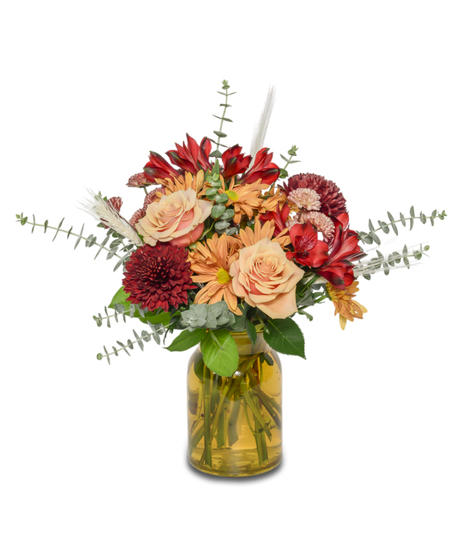 Fall floral mix of Reds and orange in a vase