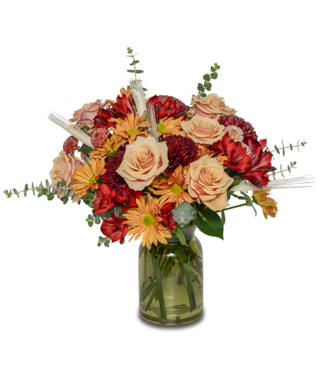 Fall floral mix of Reds and orange in a vase
