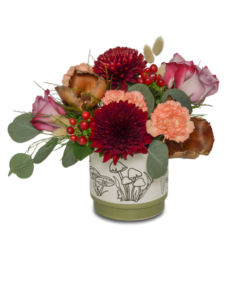 pot with mushroom engravement and fall florals.