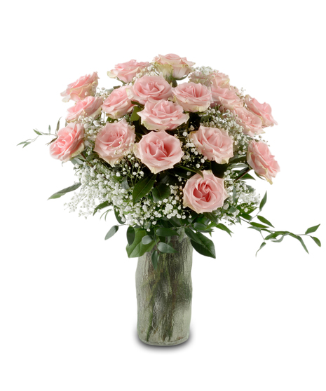 Blush pink roses arranged in a glass vase with greenery and optional baby's breath, forming a full romantic bouquet available in multiple rose counts.