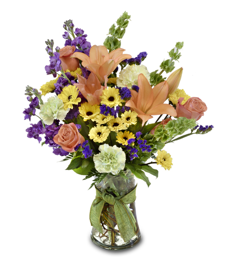 a pretty arragment of mixed flowers in a glass vase