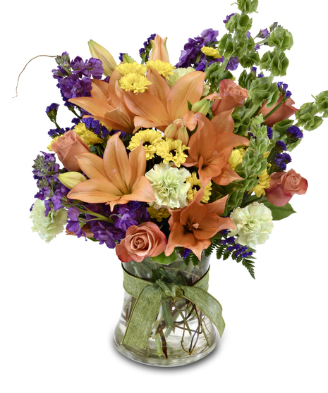 a pretty arragment of mixed flowers in a glass vase