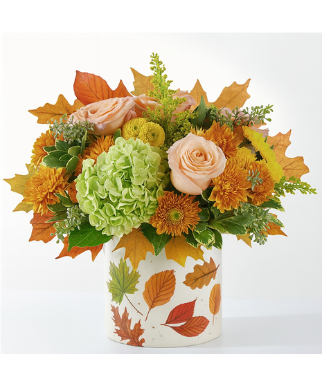 Maple Medley floral arrangement featuring peach roses, green hydrangeas, orange mums, and fall leaves in a leaf-patterned pot.