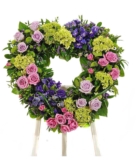 about elegant white wreath on ruscus wrapped easel from Walter Knoll  Florist, St Louis, MO