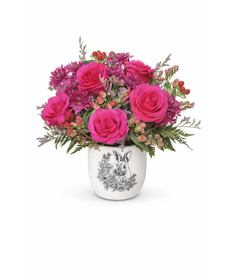 Bunny pot filled with hot pink roses, purple mums, hypericum berries, lavender limonium, and statice.