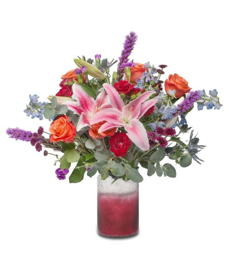A vibrant summer bouquet with Stargazer Lilies, Orange Crush Roses, blue Delphinium, purple Liatris, red miniature roses, and purple button mums.