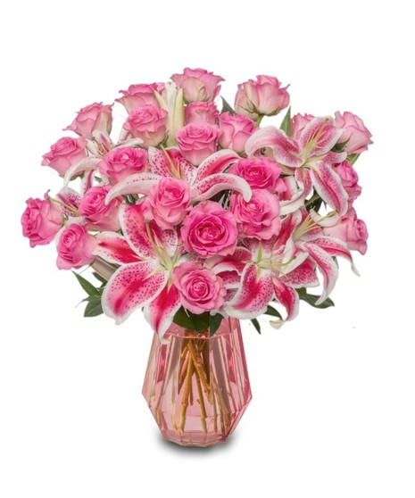 Pink Starfighter lilies arranged in a modern pink glass vase, with optional pink roses in deluxe, premium and exquisite sizes