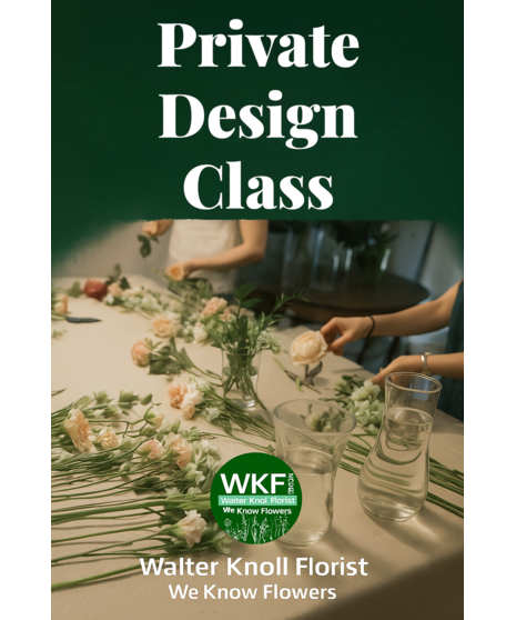 People gather around a table arranging fresh flowers with vases, tools, and stems as an instructor guides a private floral design class in a creative workshop setting.