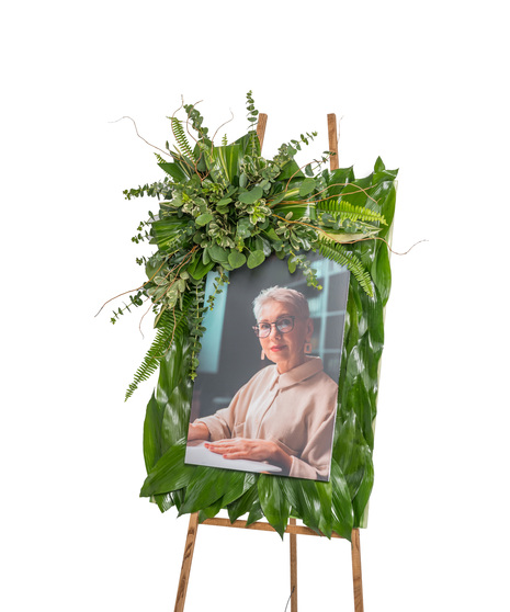 about elegant white wreath on ruscus wrapped easel from Walter Knoll  Florist, St Louis, MO