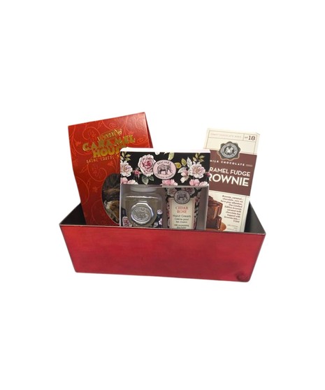 A red rectangular gift box filled with English toffee, a floral soap and lotion set, and a gourmet chocolate bar, shown upright against a white background.