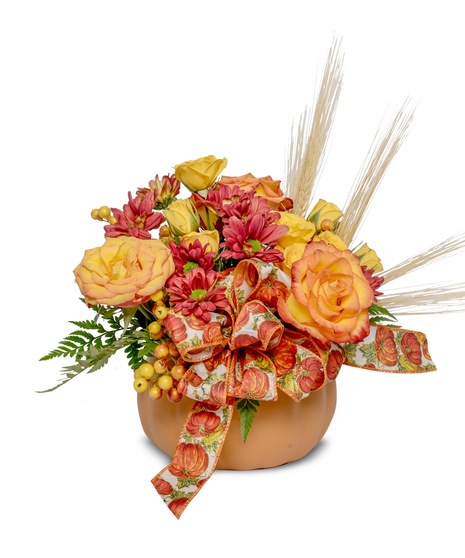 Pumpkin Harvest Arrangement - a radiant mix of fall hues, delicate roses, mums, wheat, and berries in a pumpkin. Perfect for any autumn celebration.