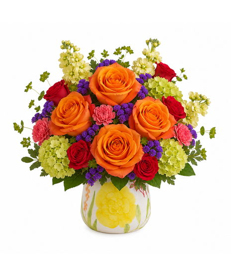 Colorful summer flower arrangement featuring orange roses, creamy stock, red spray roses, pink carnations, and purple statice in a ceramic floral vase.