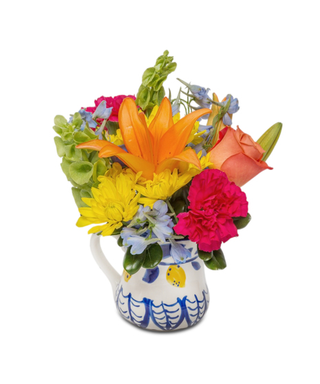 Lemonade features a mix of vibrant summer flowers in a ceramic pitcher with lemons and blue designs. Available in two sizes, bursting with cheerful color and charm.